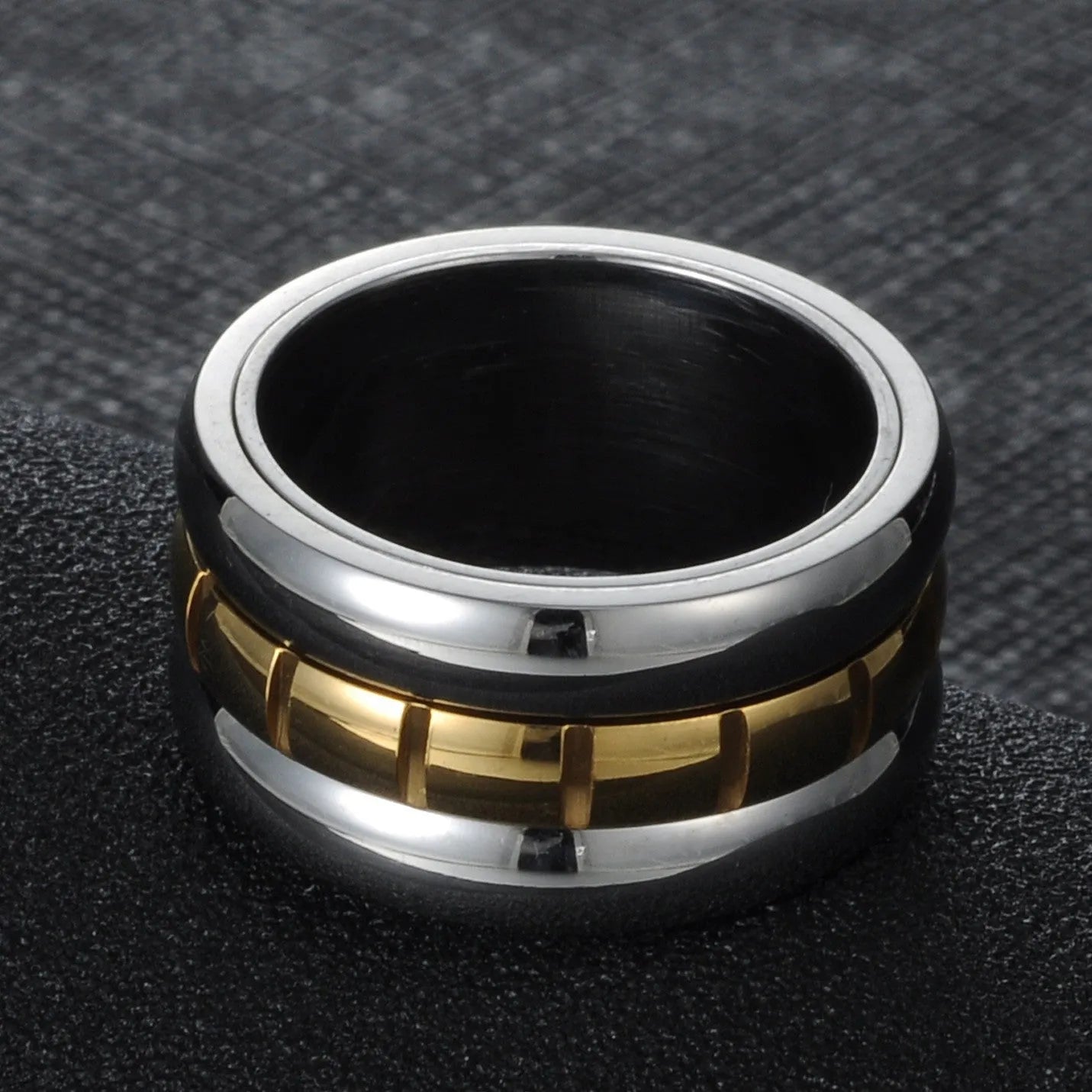 Gold titanium steel ultra-wide knuckle ring with a rotatable tail, shown on a finger.