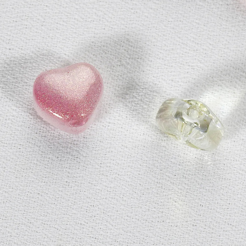 Twenty transparent Czech glass love heart spacer beads in assorted colours including aurora purple and peach gold.