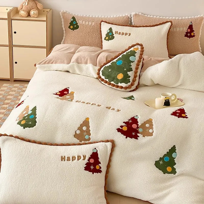 Bright yellow and white Christmas tree fleece bedding set with embroidery on a bed.