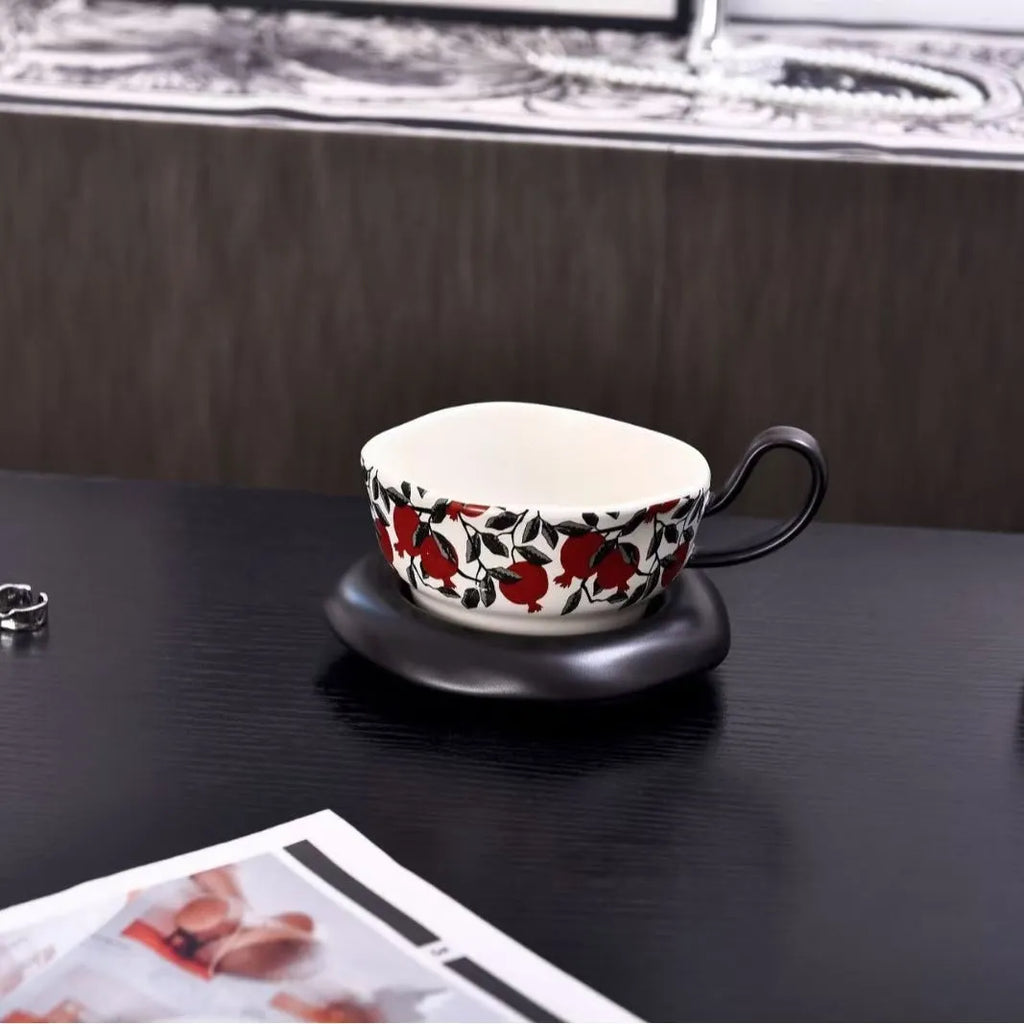 Antique style ceramic coffee cup and saucer with 210ml capacity, shown in black pomegranate and orange Citrofortunella design options.