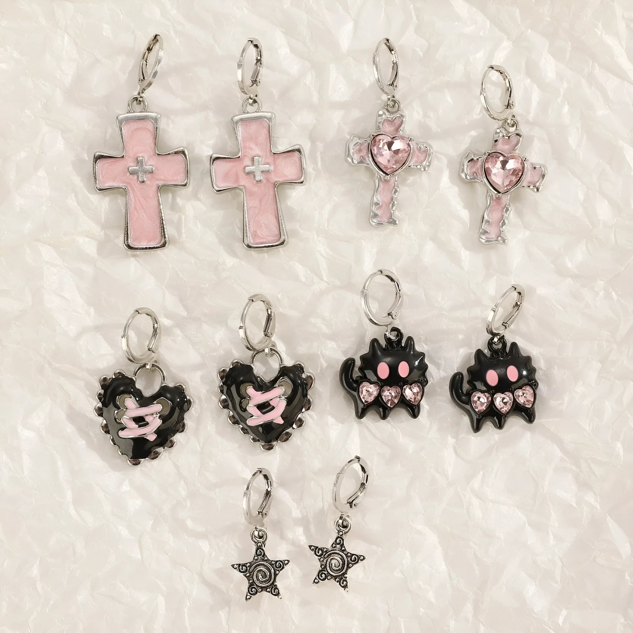 Women's alloy drop earrings showing cross, heart, and animal designs in five colour finishes