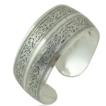Openwork ethnic bracelet with carved Miao silver finish showing elephant design detail on wrist.