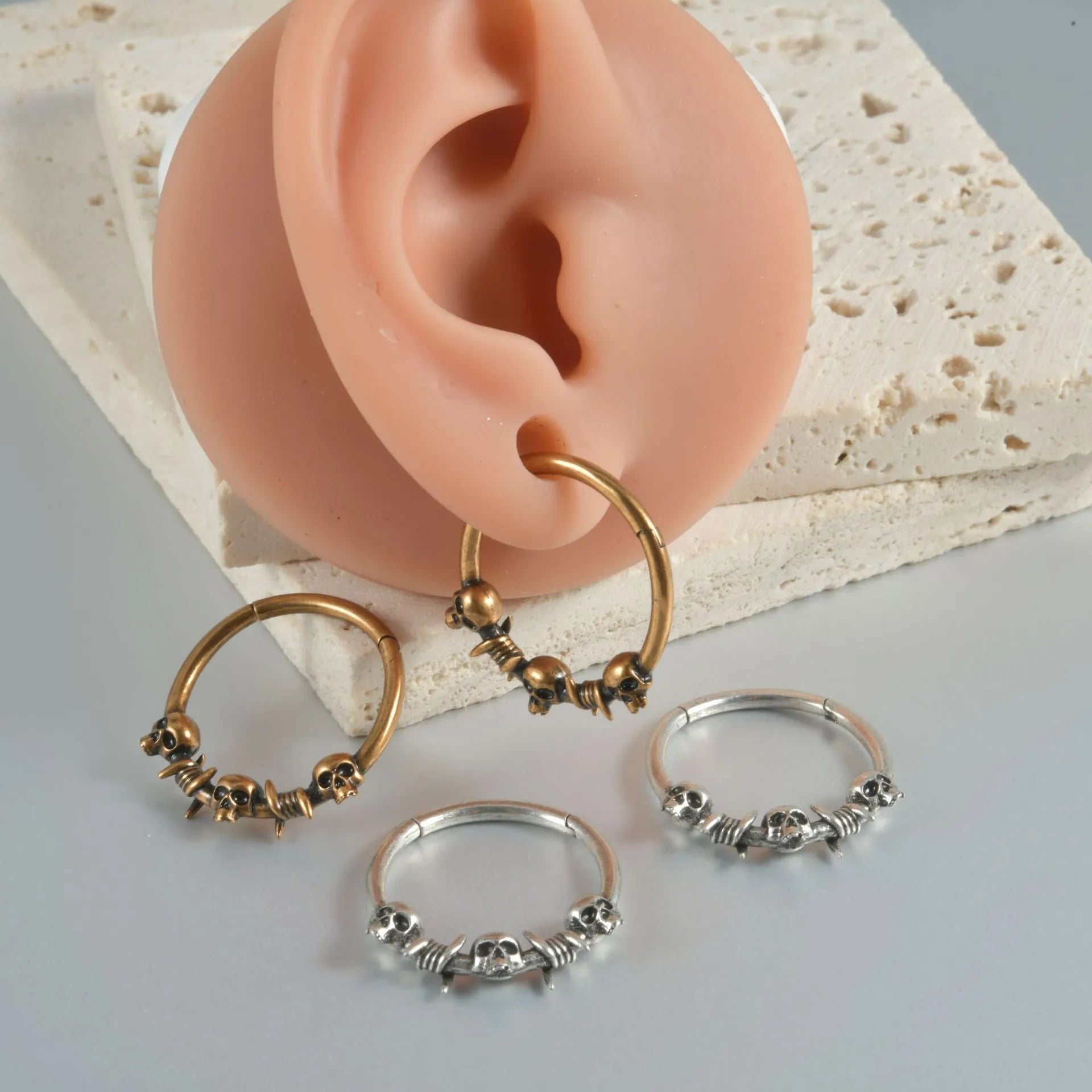 Copper punk earring with antique silver ghost head charm.