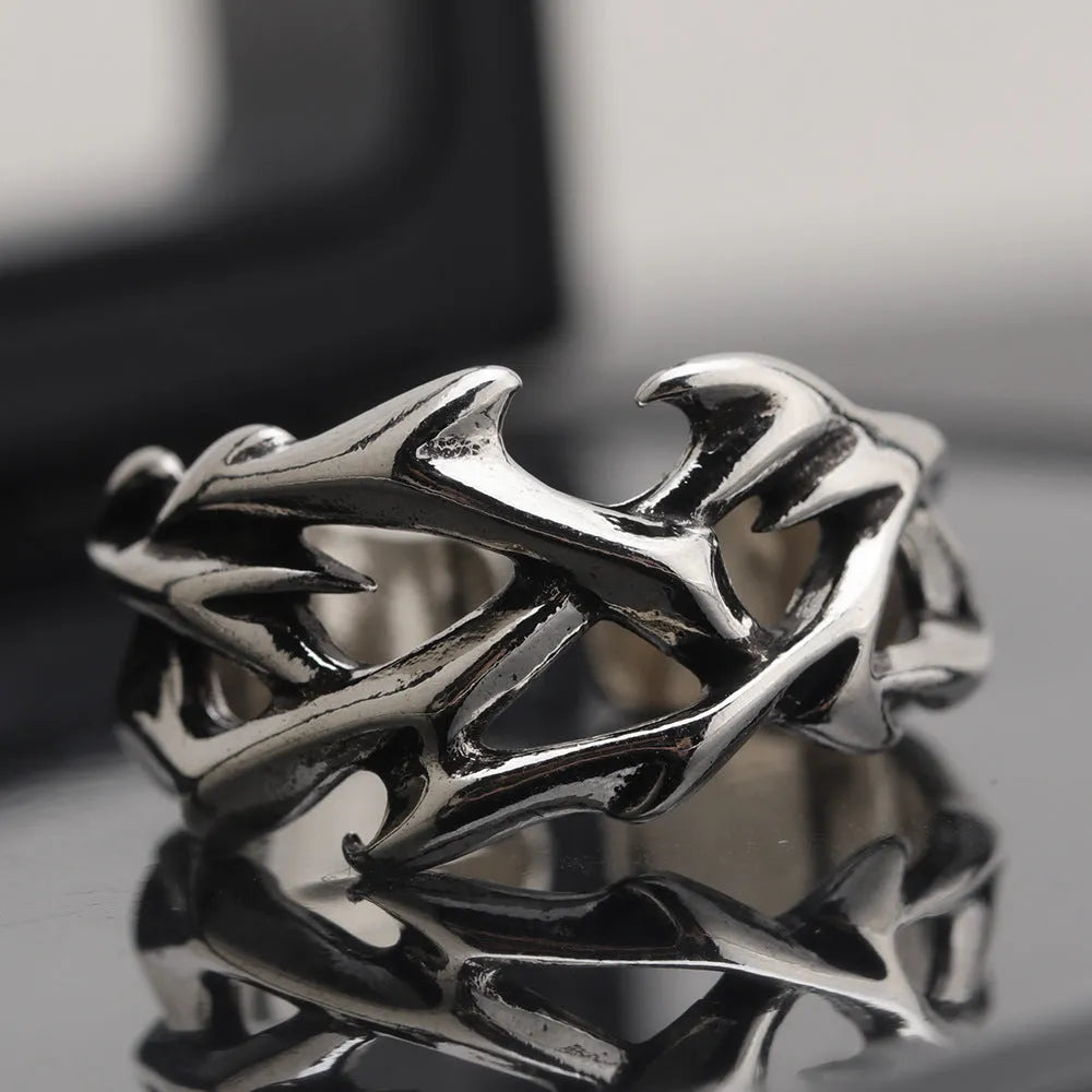 Copper men's ring with geometric thorn and flower design on an adjustable band