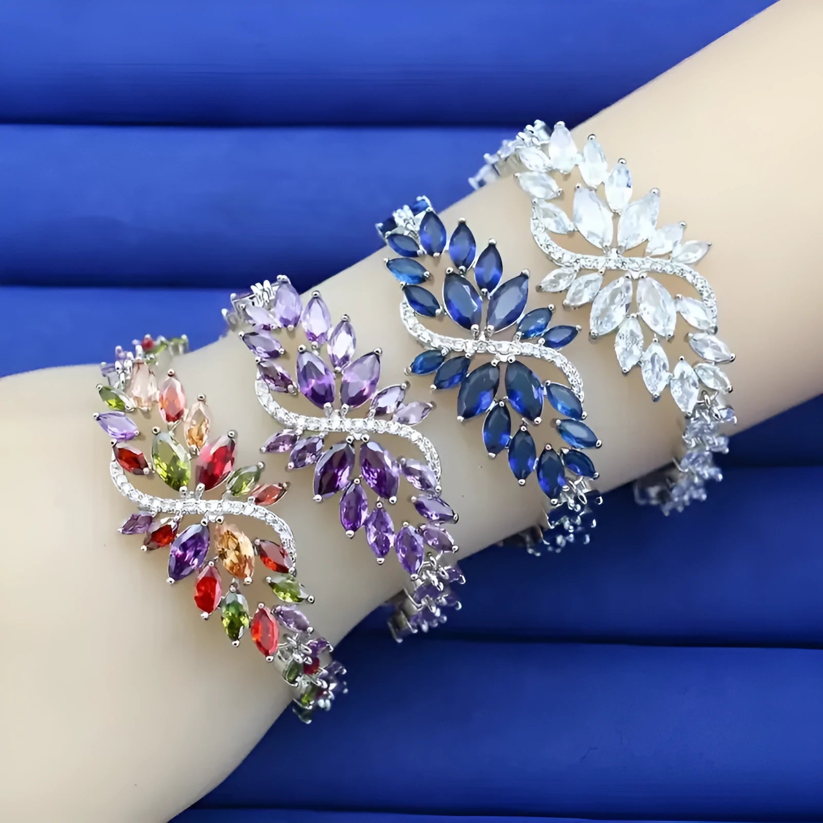 Gold electroplated copper bracelet with coloured zircon stones and ice flower detail.