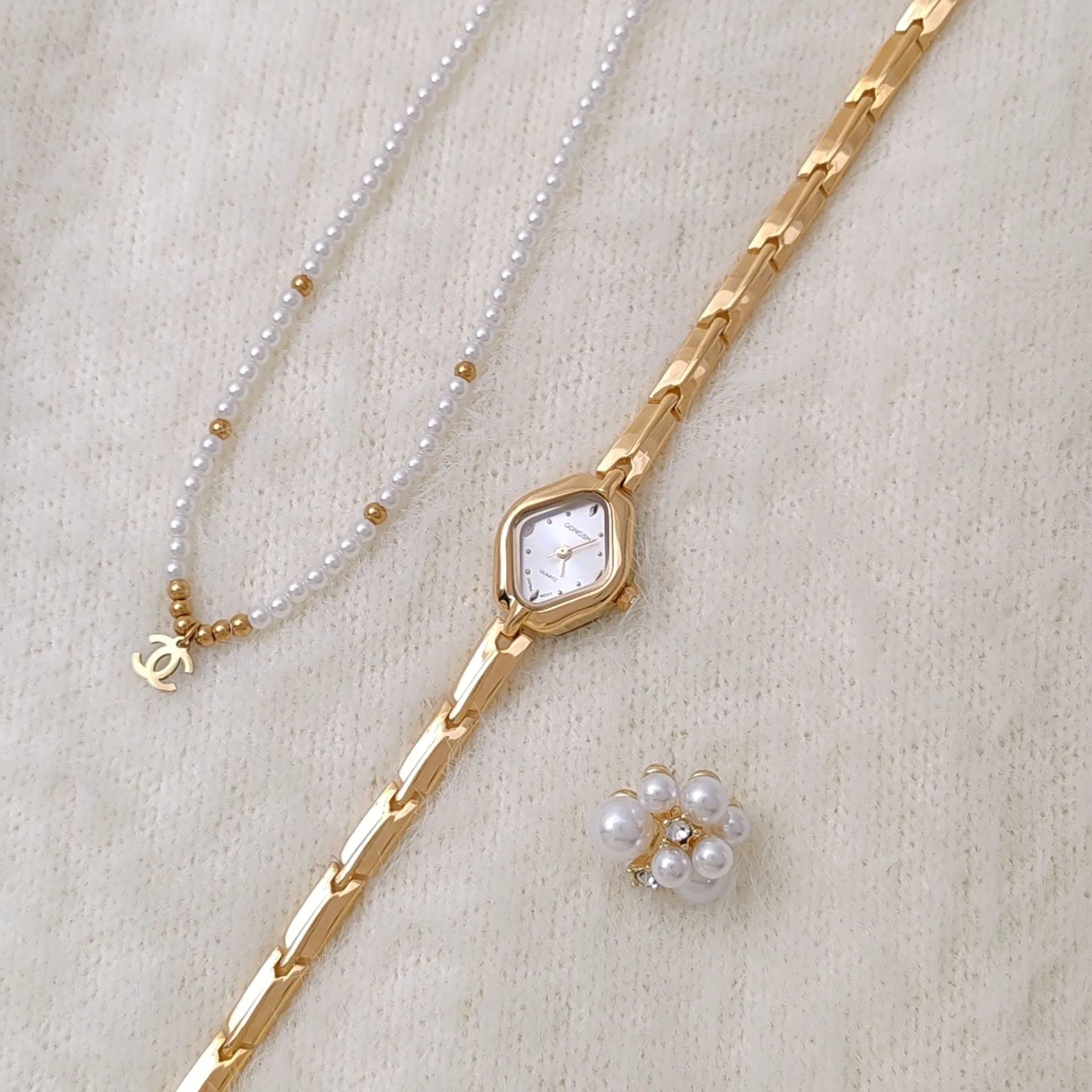 Women's gold bracelet watch with mineral glass face and metal chain strap
