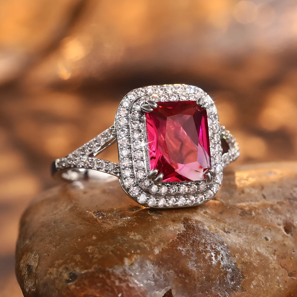 Women's geometric copper ring with a square red rhinestone on a hand.