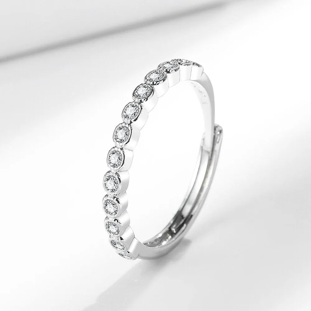 Women's open mouth geometric ring with a diamond tail, in white gold colour on a model's hand.