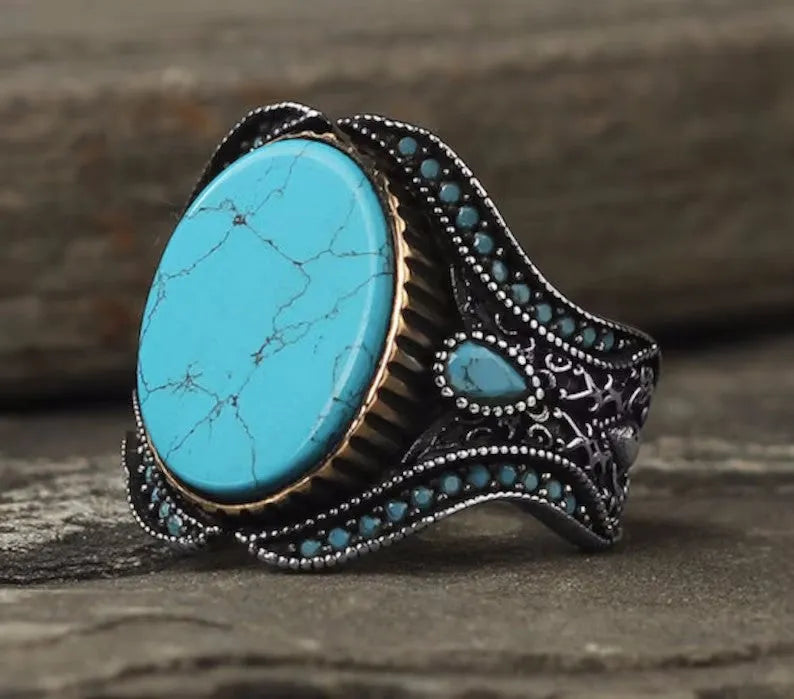 Men's round turquoise ring in antique silver alloy showing simple design and metallic finish