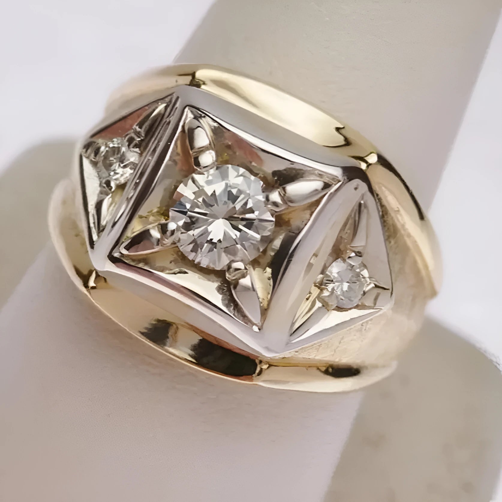 Gold-coloured geometric wide face couple rings with hollow design and chamfered square pattern.