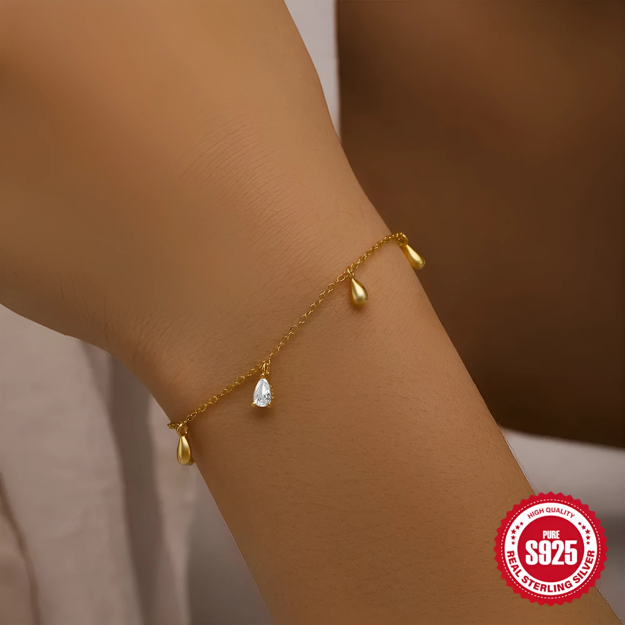Gold tone S925 sterling silver bracelet with a geometric water drop diamond pendant charm.