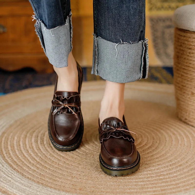 Women's black leather lace-up ankle boots with a round toe and a low chunky heel.