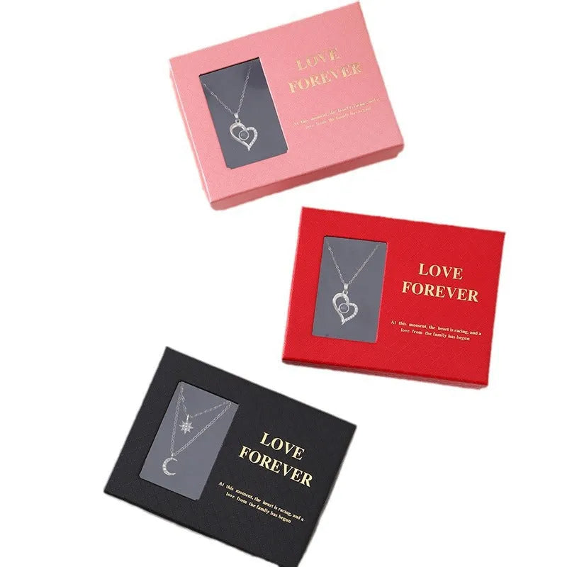 Red Valentine's gift box containing six pink soap flowers, with a matching red handbag alongside.