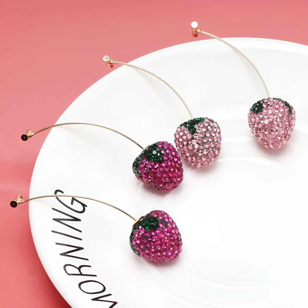 Geometric strawberry shaped zinc alloy earrings with spot drill texture on a red background.