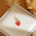 Delicate red fruit charm necklace on a titanium steel O-ring chain, showing gold and steel colour options.