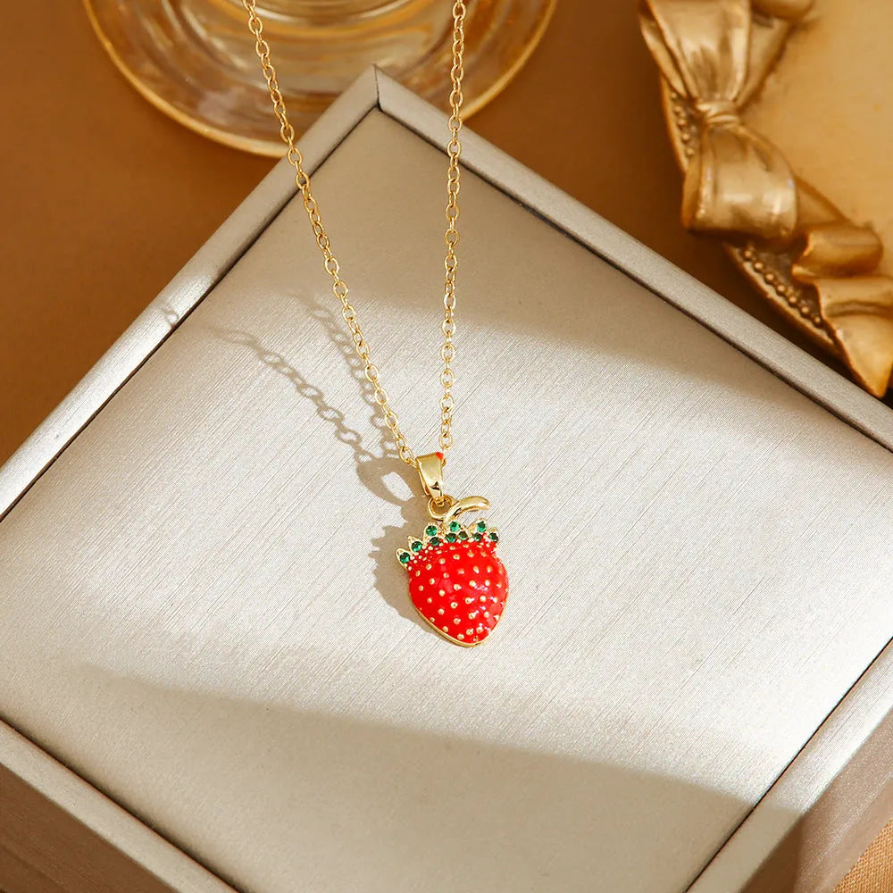 Delicate red fruit charm necklace on a titanium steel O-ring chain, showing gold and steel colour options.