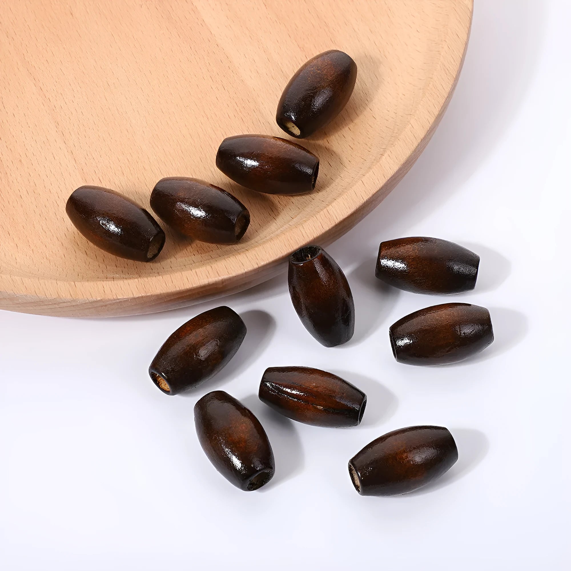 Dark coffee coloured oval wooden beads with M-shaped raised profile and baking varnish finish