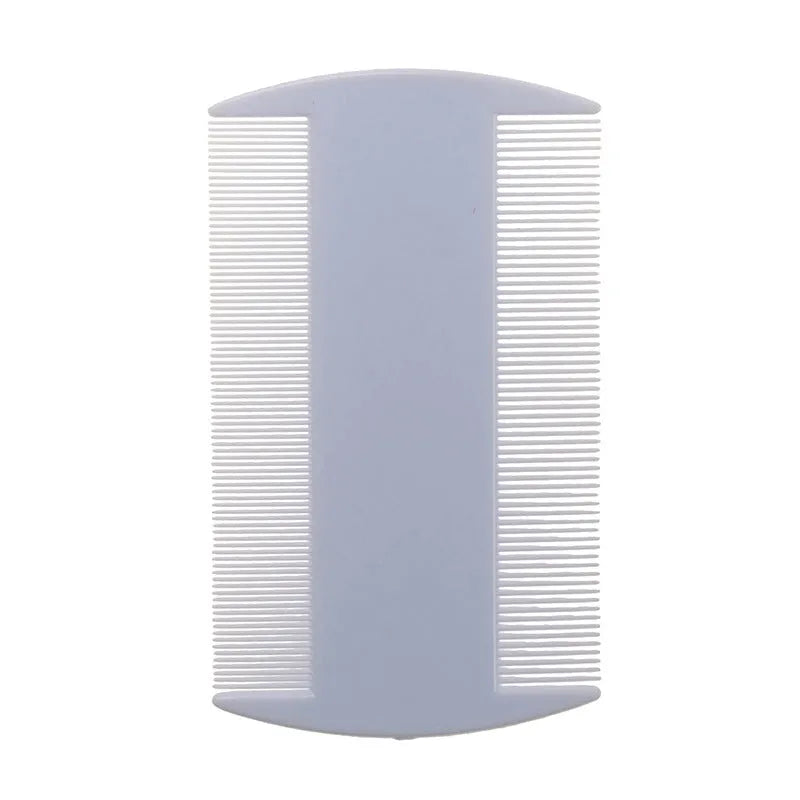 Close-up of a white double-edged fine-toothed plastic flea comb on a wooden surface.