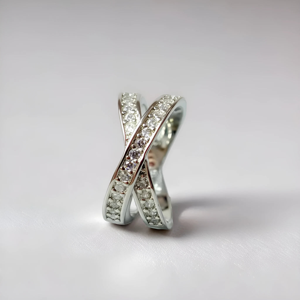 Geometric heart-shaped cross ring with micro-inlaid zircon stones in silver or rose gold finish.