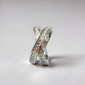 Geometric heart-shaped cross ring with micro-inlaid zircon stones in silver or rose gold finish.