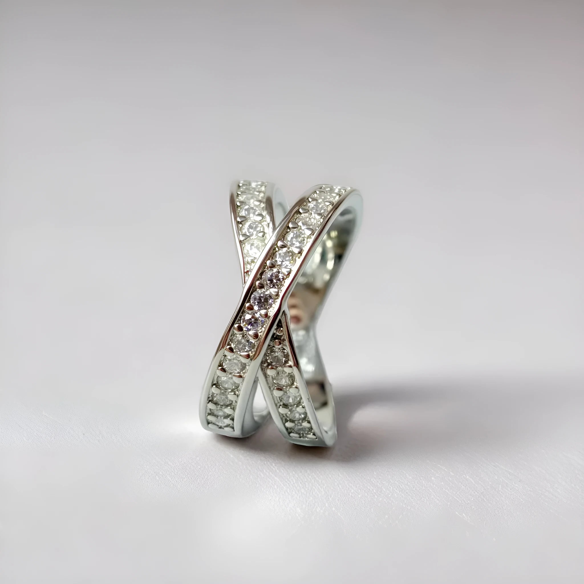 Silver and rose gold electroplated metal cross ring with micro-inlaid zircon on a copper base.