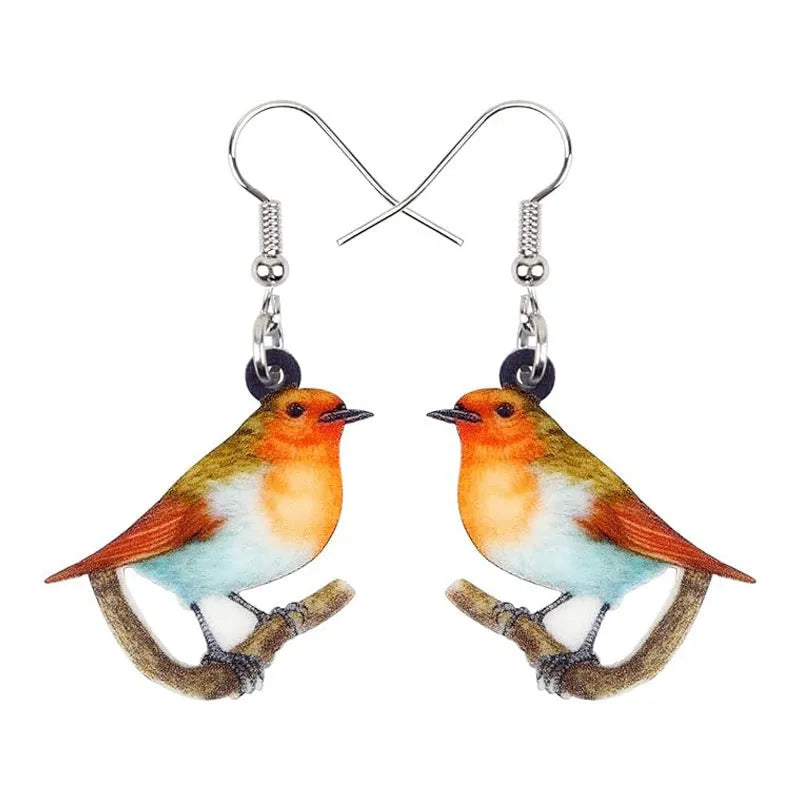 Blue, yellow, and white titmouse bird acrylic pendant drop earrings on a white background.