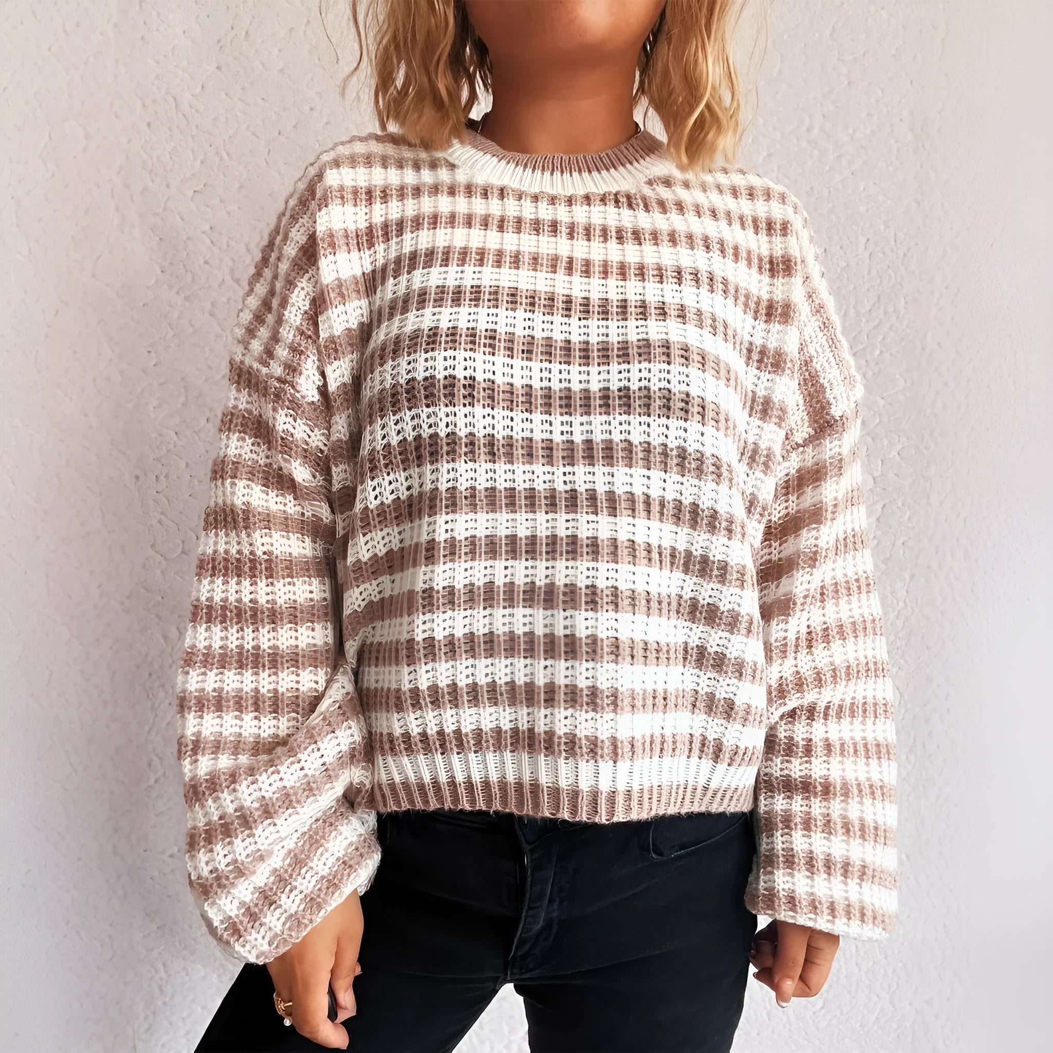 Woman wearing a vintage stripe pattern, loose-fit, long-sleeve pullover sweater.