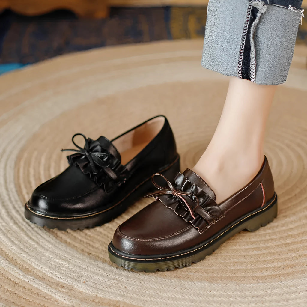 Women's black leather lace-up ankle boots with a round toe and a low chunky heel.