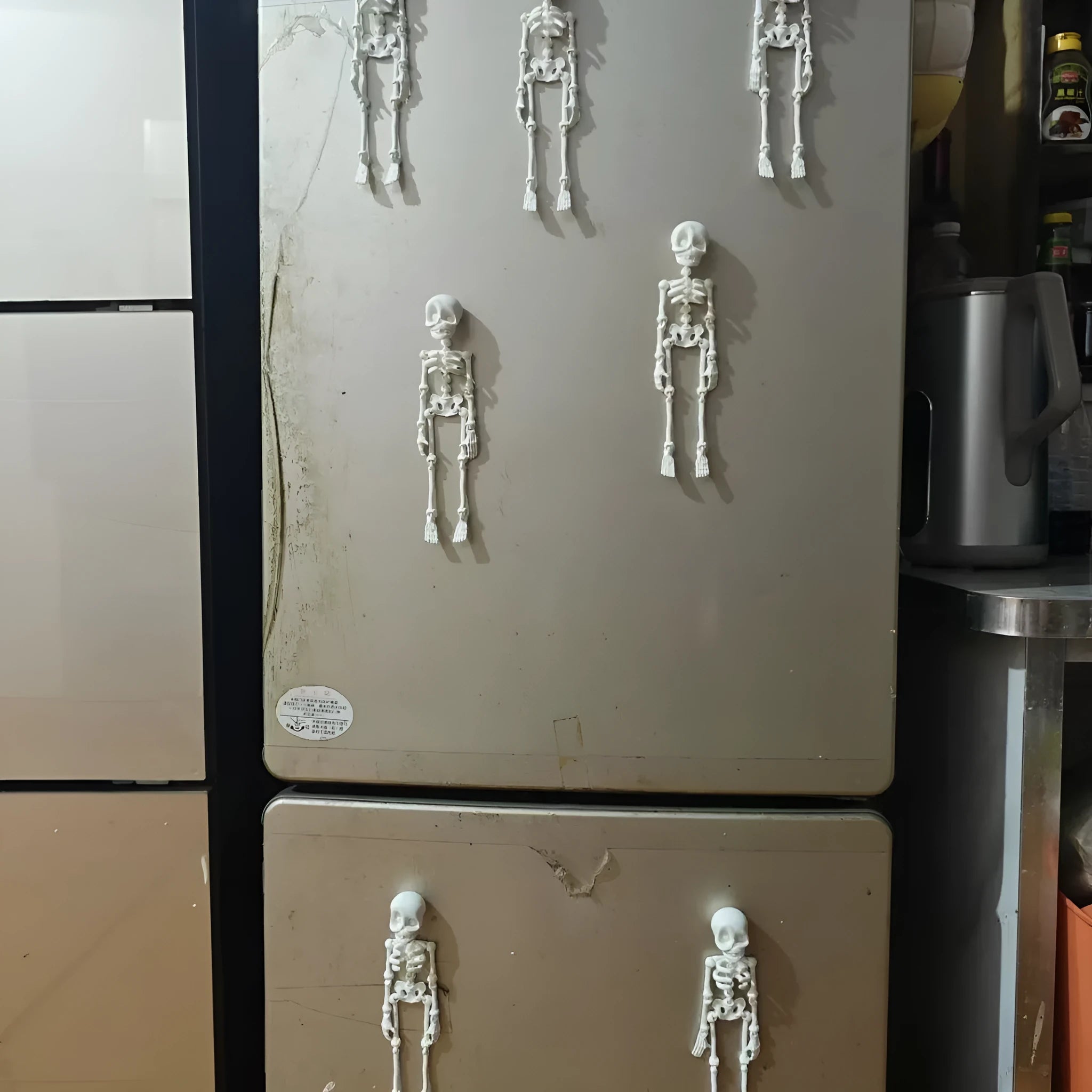 A tall 3D printed white skull refrigerator magnet for Halloween decoration.