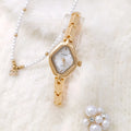 Women's gold bracelet watch with mineral glass face and metal chain strap