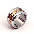 Gold titanium steel ultra-wide knuckle ring with a rotatable tail, shown on a finger.