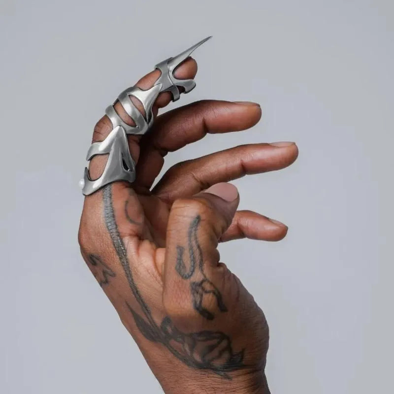 Silver-coloured alloy punk armour finger stall jewellery piece.