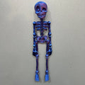 A tall 3D printed white skull refrigerator magnet for Halloween decoration.