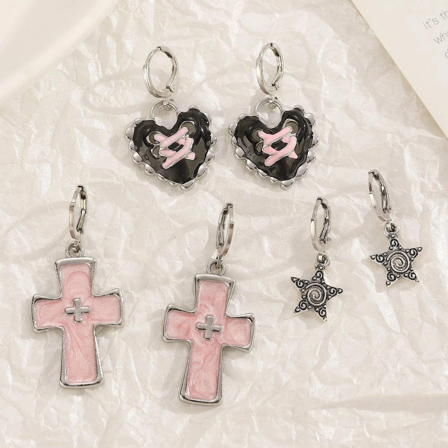 Women's alloy drop earrings showing cross, heart, and animal designs in five colour finishes