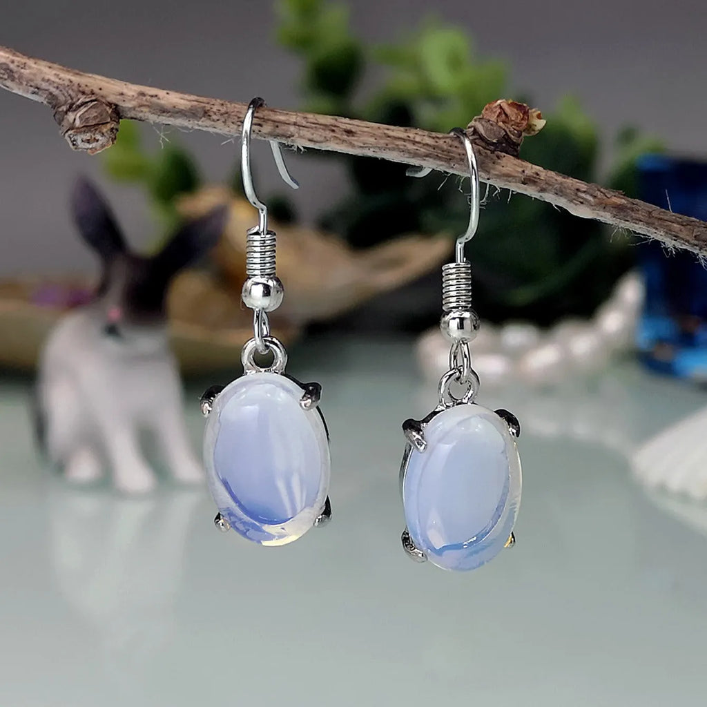 A pair of retro-style drop earrings with a moonlight opal centre on an electroplated alloy setting.