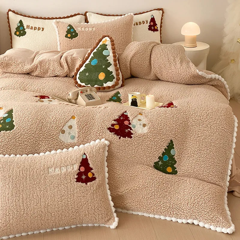 Bright yellow and white Christmas tree fleece bedding set with embroidery on a bed.