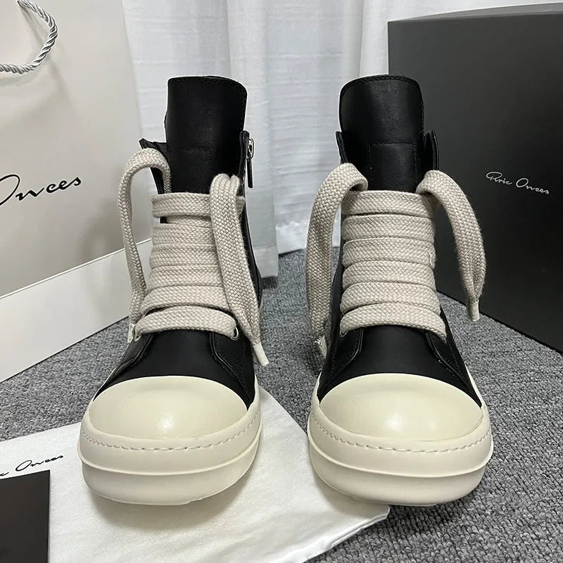 Black high-top genuine leather boots with side zip detail on a white background.