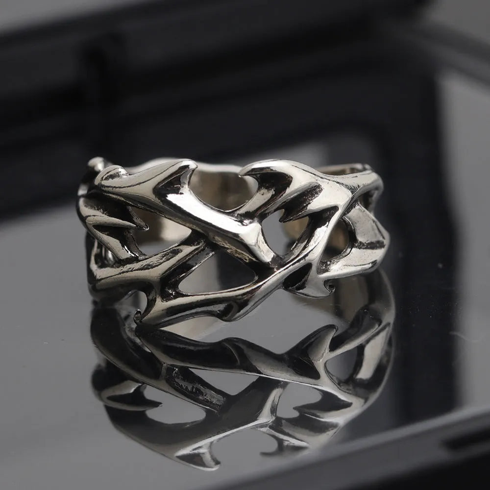 Copper men's ring with geometric thorn and flower design on an adjustable band
