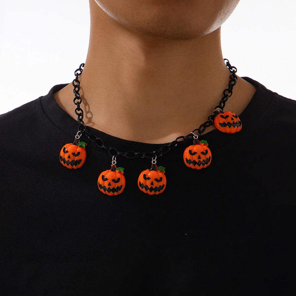 Halloween necklace showing a cartoon ghost and pumpkin acrylic pendant on a chain, colour 06705.
