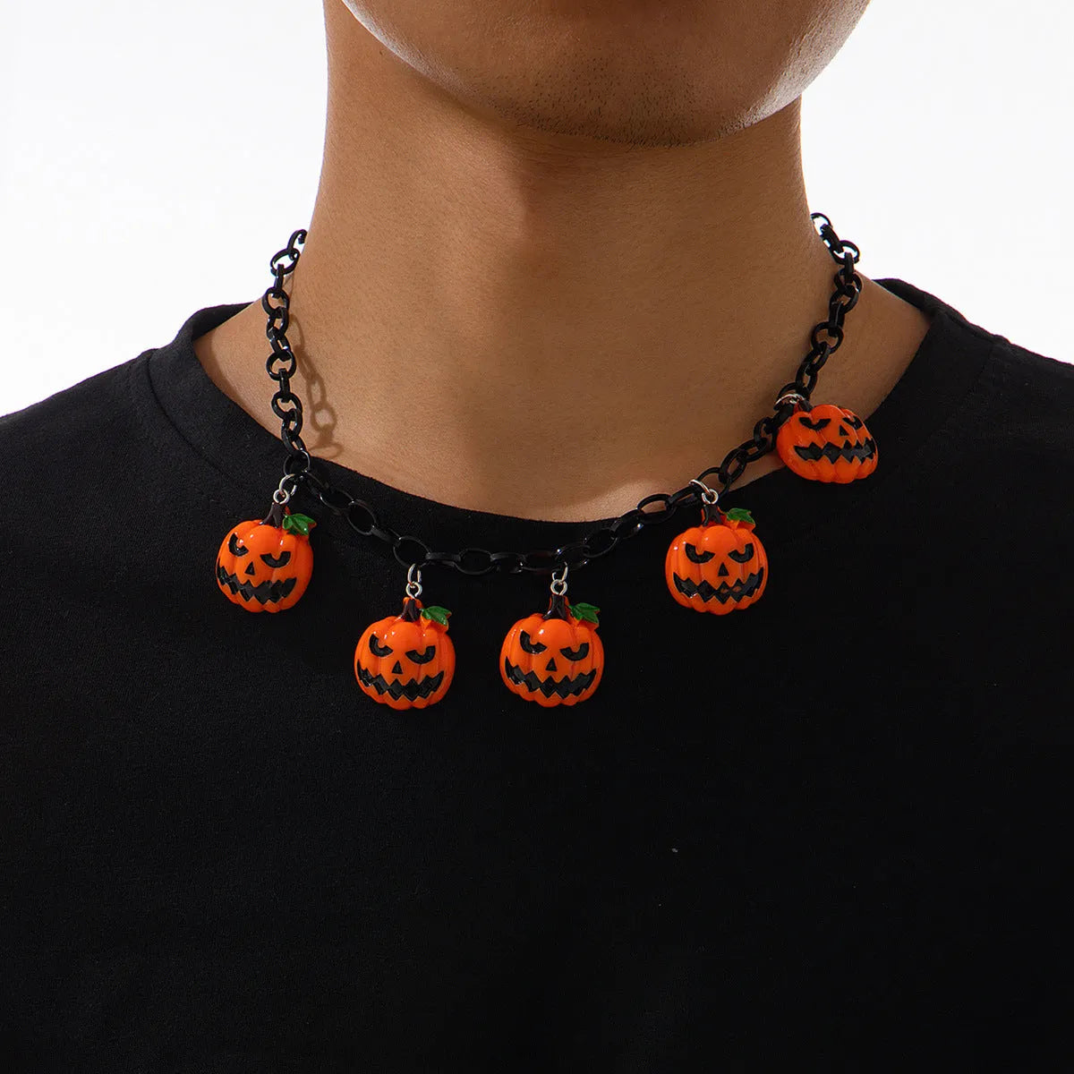 Halloween necklace showing a cartoon ghost and pumpkin acrylic pendant on a chain, colour 06705.