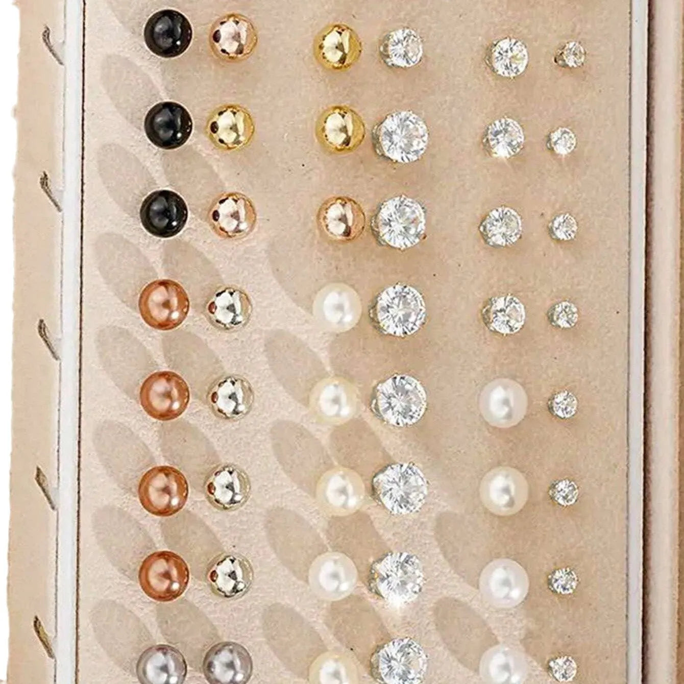 108 gold and yellow geometric alloy earrings with pearl details laid out flat.