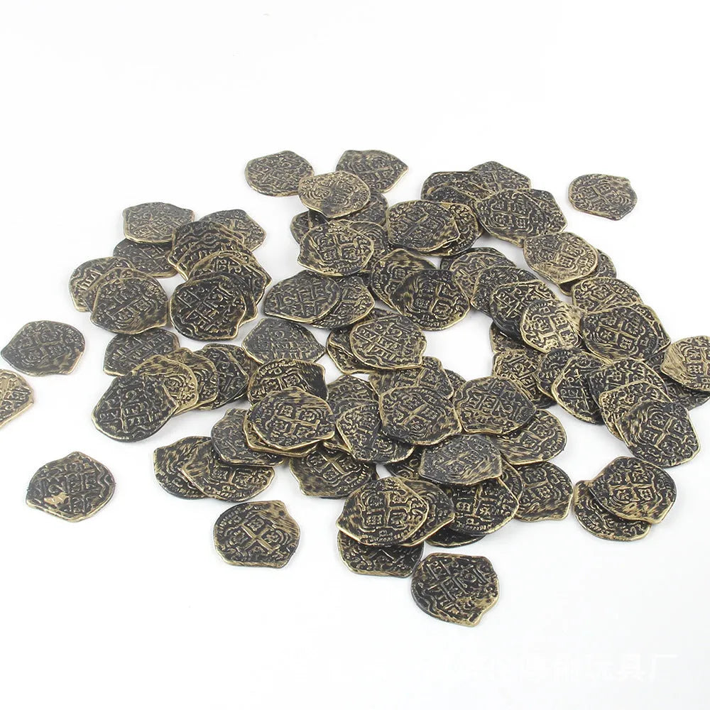 A pile of metallic gold plastic Roman pirate coins from a 100-piece pack for treasure games.