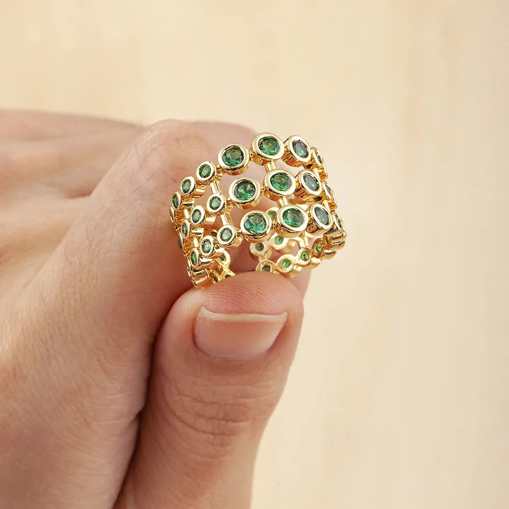 Copper ring with gold plating and green zircon stones on wide band