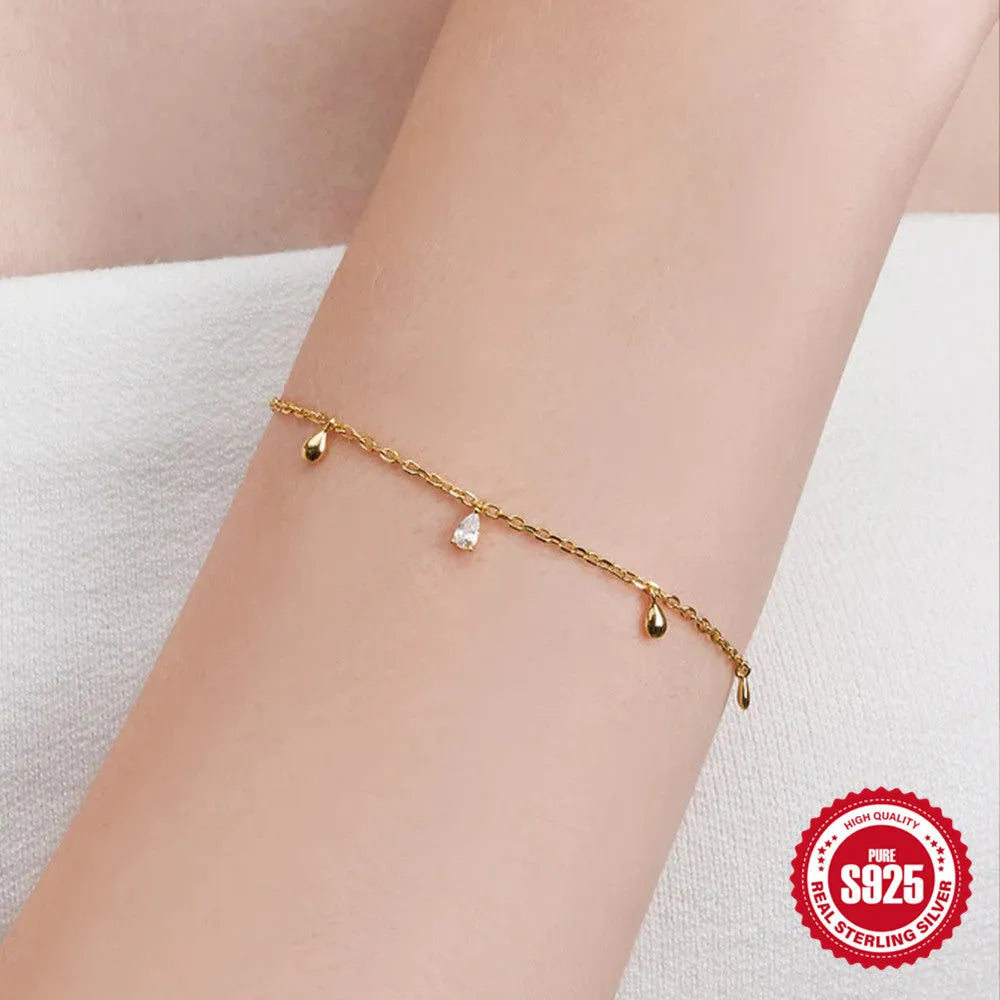 Gold tone S925 sterling silver bracelet with a geometric water drop diamond pendant charm.