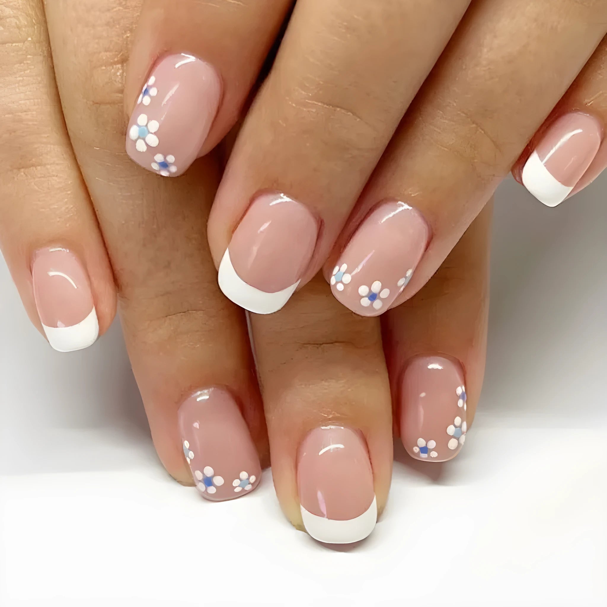 24 pieces of short wearable nail patches with white French flower pattern on plastic backing, with jelly glue wipe
