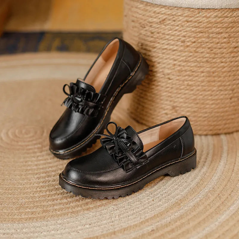 Women's black leather lace-up ankle boots with a round toe and a low chunky heel.