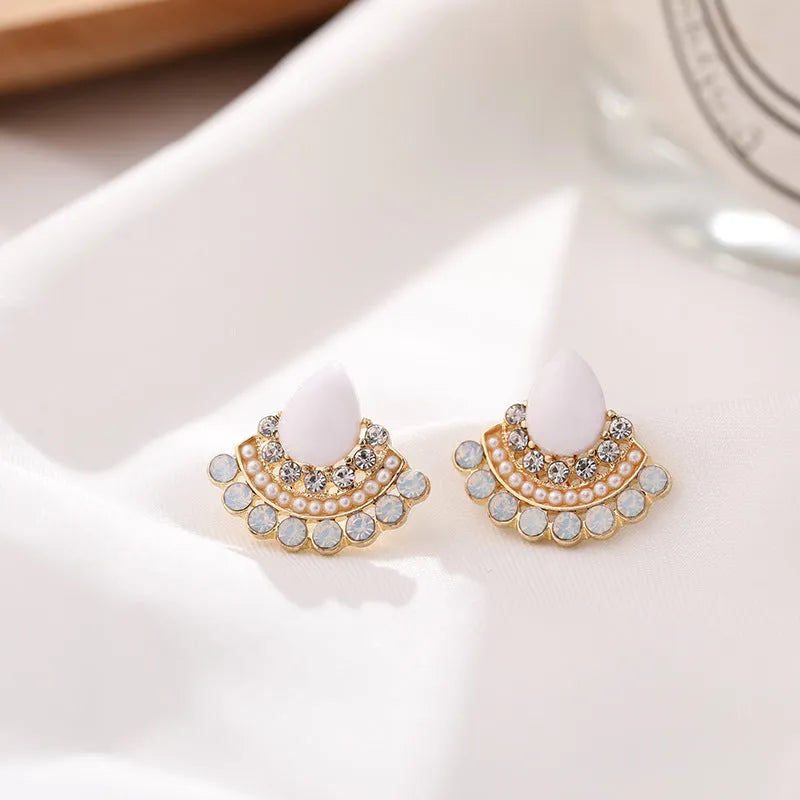 Retro silver geometric fan-shaped drop earrings with rhinestone and opal-style details.