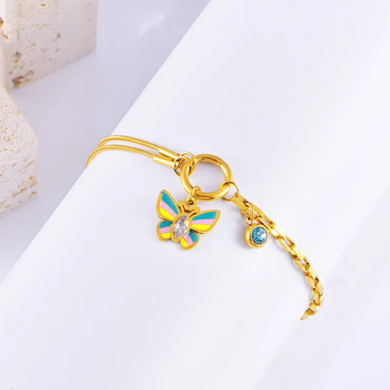 Gold tone epoxy butterfly pendant necklace and bracelet set with snake bone chain.