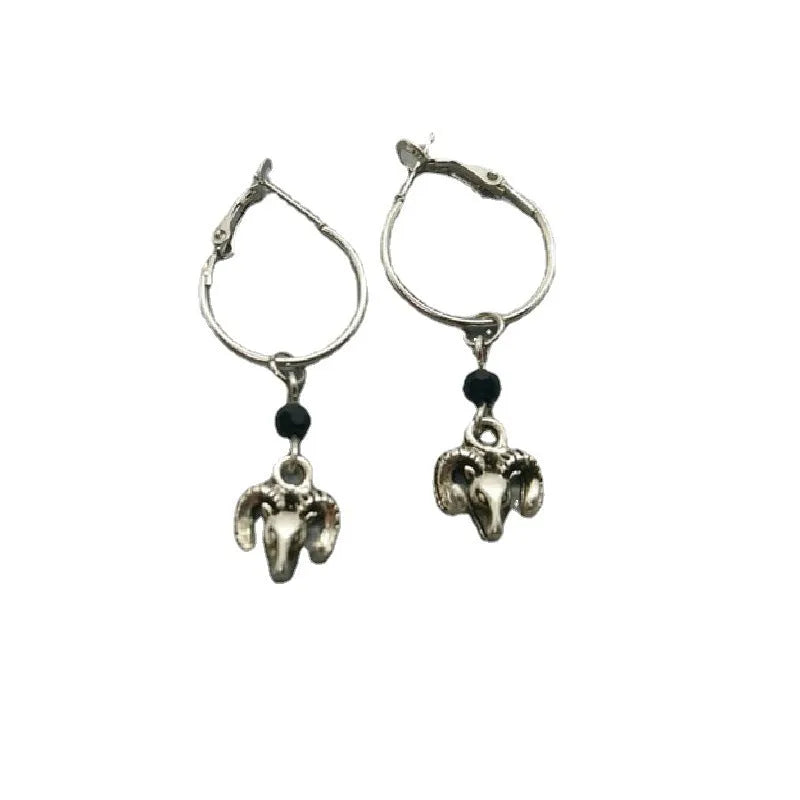 A pair of silver-coloured alloy round ring earrings with a Tibetan antelope design motif.