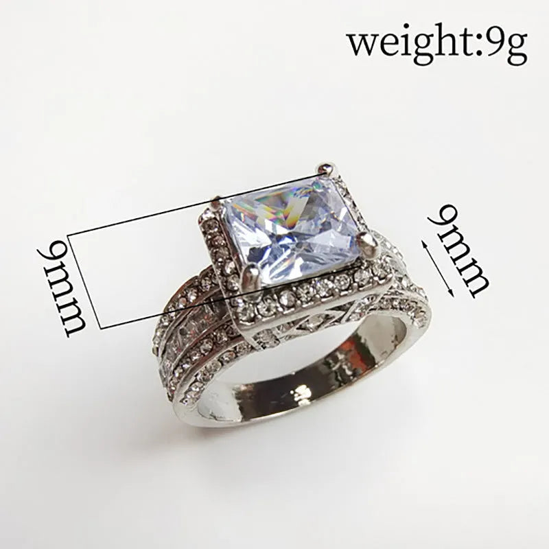 Geometric round silver fashion ring for women in gold or white tone on a grey background.
